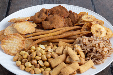 A selection on Nigerian local snacks. Kokoro, kuli kuli, chin chin, gurundi, plantain chips,...