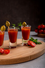 The shorts with the alcoholic drink Bloody Mary are decorated with olives. Close-up.