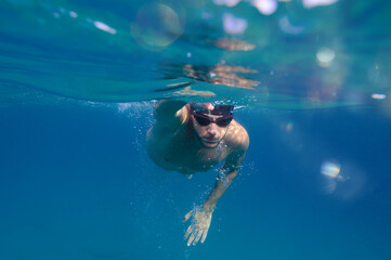 Sporty man swims fast in the sea