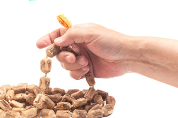 Rosary or prayer beads in a man's hand isolated on white background.