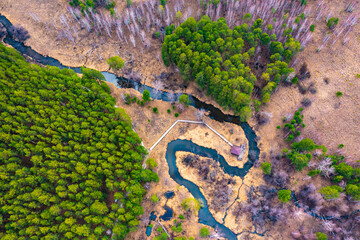Aerial top down view plain river Psel during spring time. Beautiful valley of riverbed with green meadows of grass and willow trees. Beauty of summer nature. River delta loop from above.