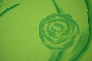 floral pattern painted on the wall, green abstract crooked shape on green light background, green wallpaper