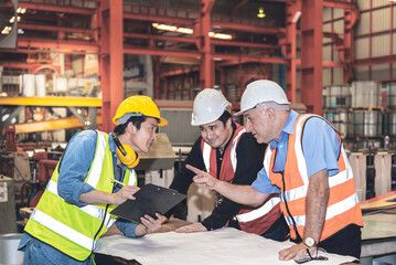 Two Caucasian male engineer and Asian maintenance engineer, are working together, Consulting and...