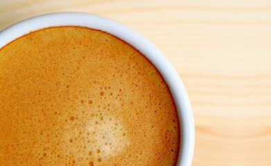 Top view of artistic texture of frothy hot coffee surface