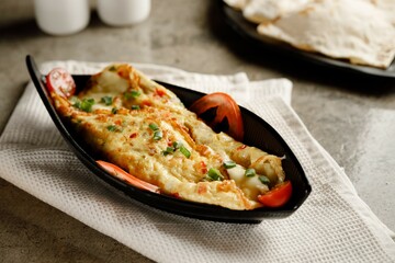 Vegetable omelet served in a dish isolated on grey background side view fast food
