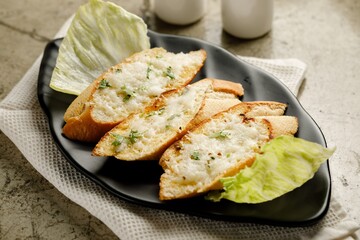 Garlic Cheese Bread served in a dish isolated on grey background side view fast food