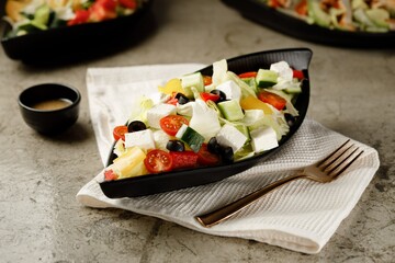 Greek Salad served in a dish isolated on grey background side view fast food