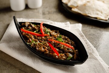 spicy meat liver masala served in a dish isolated on grey background side view fast food