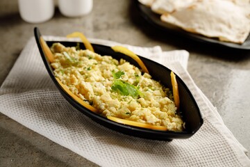 Scrambled egg with cheese served in a dish isolated on grey background side view fast food - obrazy, fototapety, plakaty