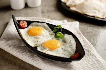 Sunny Sider Egg served in a dish isolated on grey background side view fast food