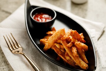 Sweet Potato Fries with ketchup served in a dish isolated on grey background side view fast food