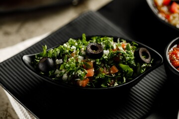 Tabouleh Salad served in a dish isolated on grey background side view fast food