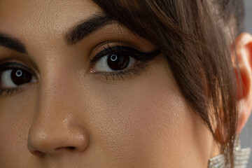 Beautiful macro of expressive brown eyes with fashionable pink smoky shadows, extremely long...