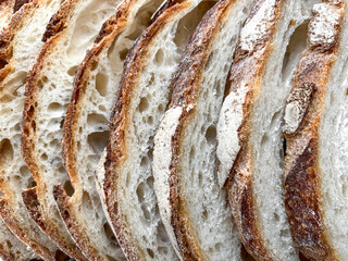 Slices of  fresh bread background. Freshly baked and sliced San Francisco sourdough loaf bread Food...