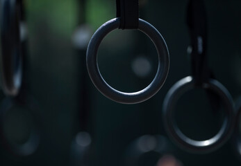 Gymnastics rings on dark background. Horizontal sport theme poster, greeting cards, headers, website and app