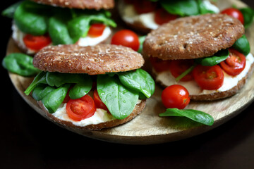 Healthy sandwiches with spinach, cherry tomatoes and white cheese. Useful snack. Keto diet.