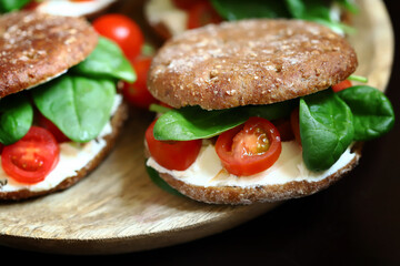 Healthy sandwiches with spinach, cherry tomatoes and white cheese. Useful snack. Keto diet.
