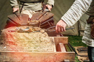 Work of a medieval blacksmith for the manufacture of metal products. Reconstruction of the events of the Middle Ages in Europe.