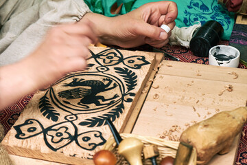 Wooden stamps for medieval ink printing on fabric and vintage clothing. Reconstruction of the events of the Middle Ages in Europe.