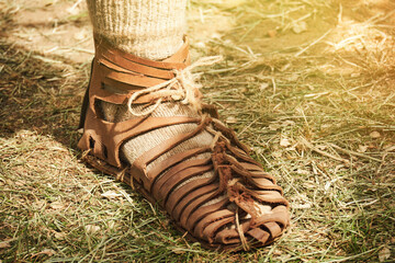 An ancient Roman man legs in caligae leather sandals. Reconstruction of the events of the Roman...
