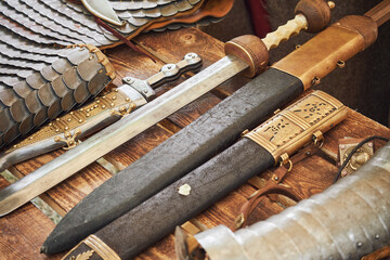 Ancient Roman weapons and armor - swords and chain mail. Reconstruction of military events during...