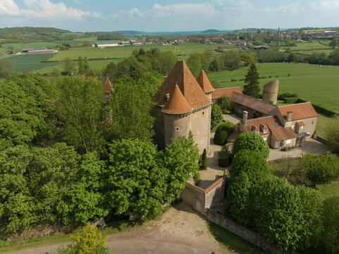 Aerial view of the Pancy castle in Angely Burgundy France with central keep protected by two circular towers, large outbuildings create a U-shaped wind around the courtyard standalone circular tower 