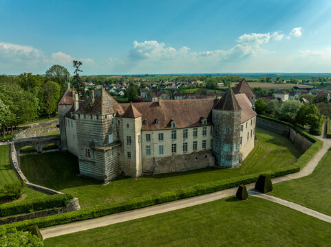 Aerial view of the feudal castle of Epoisses with buildings from the 10th century and major updates from the 14th and 18th century. The castle has a large defensive moat all around
