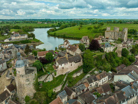 Aerial view of Bourbon-L'Archambault castle of the royal family ruined during the revolution, with three circular towers , Gothic arches surviving on a hilltop over the sleepy small French town 