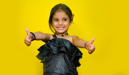 best of luck, cheerful small girl image isolated on yellow color background