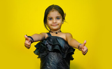 best of luck, cheerful small girl image isolated on yellow color background