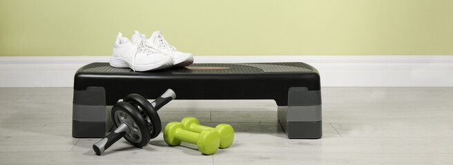 Step platform and different sports equipment indoors. Banner design