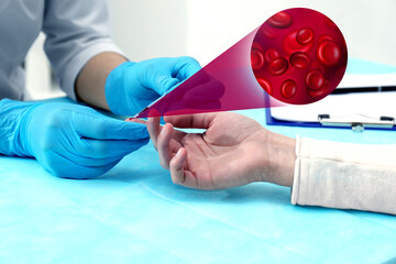Doctor taking blood sample from patient's finger at table in clinic, closeup