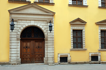 Fototapeta na wymiar View of house with beautiful arched wooden door and grated windows. Exterior design