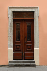 Fototapeta na wymiar View of building with vintage wooden door. Exterior design