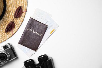Flat lay composition with passport, tickets and holiday items on white background. Space for text