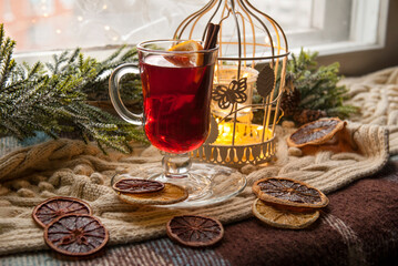 Mulled wine with citrus fruits and spices. Winter grog with orange and cinnamon on a background of...