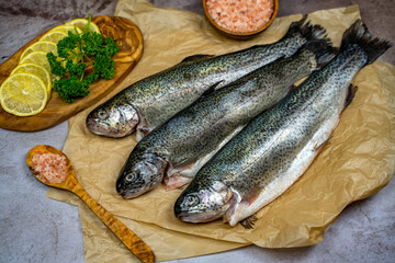 Three raw trout ready to be cooked.
