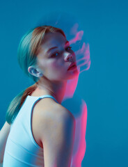 Beauty portrait of modern young girl wearing white top in pink neon light with long exposure....