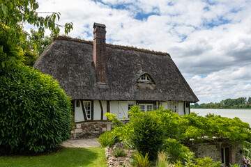 Fototapeta na wymiar A thatched cottage in Normandy, on the banks of the Seine, beautiful house 