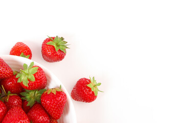 Red ripe strawberry in the white bowl