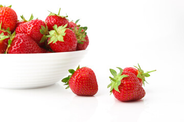 Red ripe strawberry in the white bowl