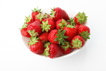 Red ripe strawberry in the white bowl