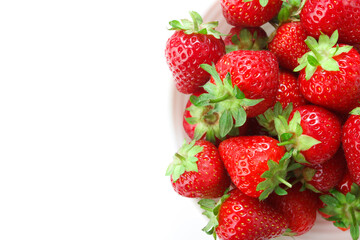 Red ripe strawberry in the white bowl
