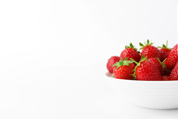 Red ripe strawberry in the white bowl