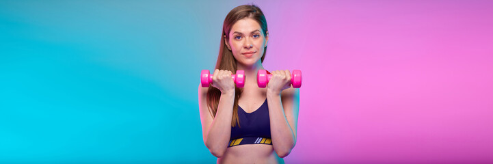 sporty woman with pink dumbbells. Female fitness portrait isolated on neon color background.