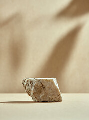 Natural podium of stone. Rock, beige bottom and background. Minimalistic pedestal for cosmetics.
