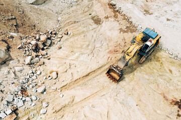 Aerial photo of excavator on industrial place. Industrial site top view. Shooting from the drone.