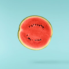 Fresh raw watermelon falling in the air isolated