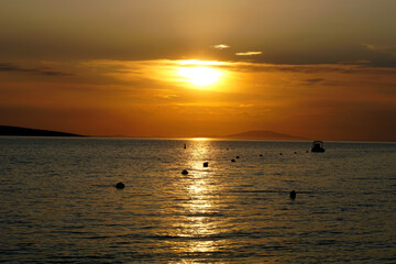 The reflection of the sun rays in the surface of the sea during sunset at the golden hour