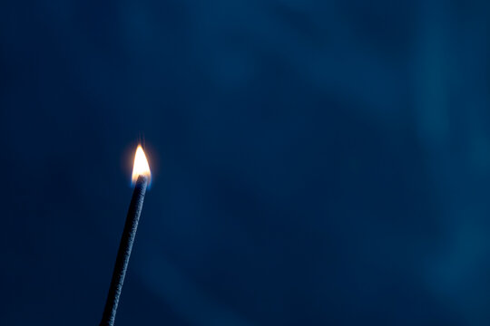 burning match on a dark background